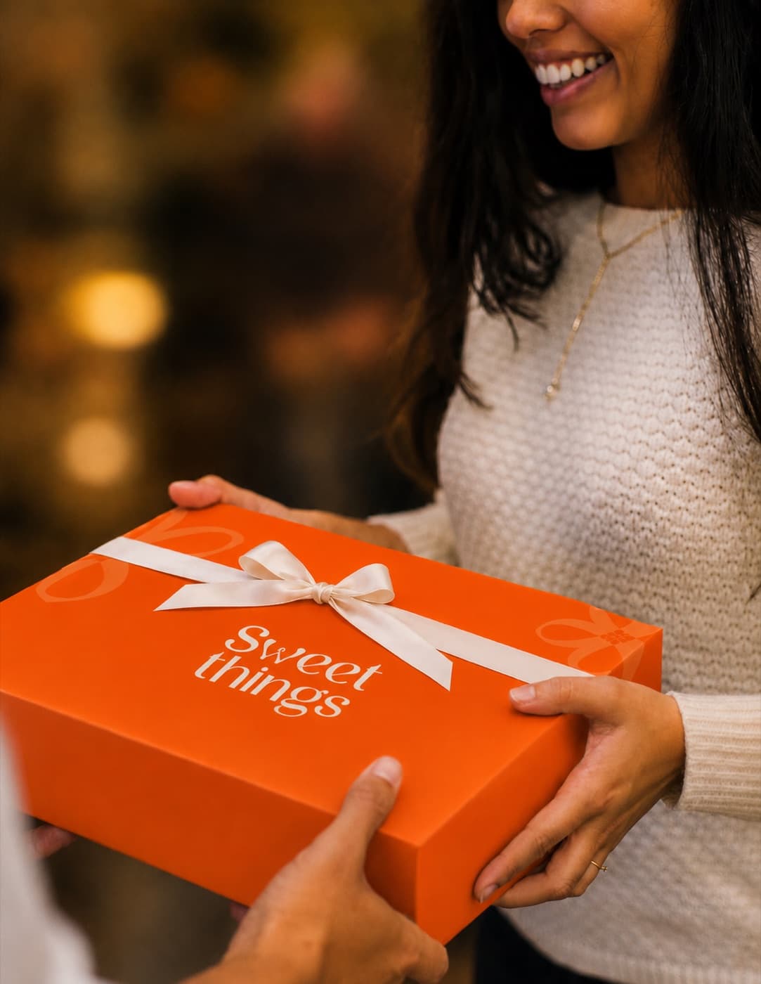 A Sweet Things gift box tied with a satin bow